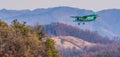 Biplane flying over mountainous region