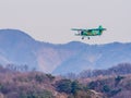 Biplane flying over mountainous region