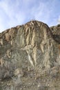 A chunk of mountain, with blue sky, at Knox mountain park in Canada