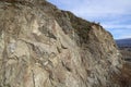 A chunk of mountain, with blue sky, at Knox mountain park in Canada