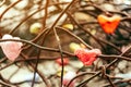 A chunk of a red heart shaped candle adheres to an old rusted steel rod.