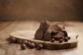 Chunks of gianduja with hazelnuts on wood board Royalty Free Stock Photo