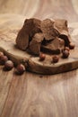 Chunks of gianduja with hazelnuts on wood board Royalty Free Stock Photo