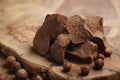 Chunks of gianduja with hazelnuts on wood board Royalty Free Stock Photo