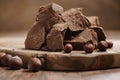 Chunks of gianduja with hazelnuts on wood board Royalty Free Stock Photo