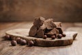 Chunks of gianduja with hazelnuts on wood board Royalty Free Stock Photo