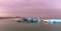 Chunks of glacial ice float during sunset