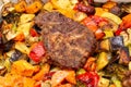 Chunks of pork baked on a baking sheet in the oven with spiced potatoes, bell peppers, zucchini, pumpkin and broccoli. Homemade Royalty Free Stock Photo