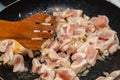 Chunks of raw chicken meat, fried in a pan with uk. Royalty Free Stock Photo