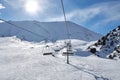 Chunkurchak ski resort in Kyrgyzstan. Empty ski lift seats. Mountain slope at sunny winter day