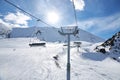 Chunkurchak ski resort in Kyrgyzstan. Empty ski lift seats. Mountain slope at sunny winter day