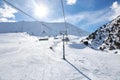 Chunkurchak ski resort in Kyrgyzstan. Empty ski lift seats. Mountain slope at sunny winter day