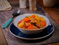 Chunky beef casserole in rustic setting.