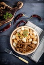 Chunky beef stew with savory sauce beside potato dumplings. Royalty Free Stock Photo