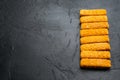 Chunky breaded frozen fish fingers, on black background , with copyspace  and space for text Royalty Free Stock Photo