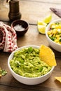 Chunky homemade guacamole in a bowl with tortilla chips Royalty Free Stock Photo