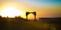 Chuppah silhouetted by the golden setting sun
