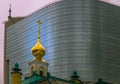 Church on a background of a modern high-rise building