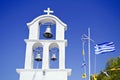 Church belfry and the greek flag waving Royalty Free Stock Photo