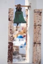 Church bell against churches in Oia village on Santorini island, Greece Royalty Free Stock Photo