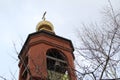 Church bell tower with a Golden dome and a cross against the sky in Russia Royalty Free Stock Photo