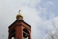 Church bell tower with a Golden dome and a cross against the sky in Russia Royalty Free Stock Photo