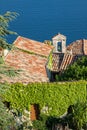 Church bell tower and tiled roof on seaside Royalty Free Stock Photo