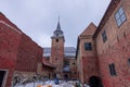 Church and belltower in akershus fort in Oslo on a cold winter day. Visible houses and big belltower made of red brick. Royalty Free Stock Photo