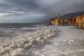 The church and the big wave in Camogli Genoa, Italy. Royalty Free Stock Photo