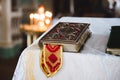 Church book on white tablecloth with candals