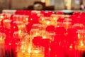 Church burning candles in glass candlesticks.