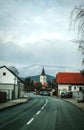 A church can be seen in small village with the alps behind it. Royalty Free Stock Photo