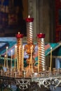 Church candles are burning on a large golden vintage candlestick in the orthodox church. Christian faith and traditions. Theme of Royalty Free Stock Photo