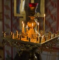 Church candles in red and yellow transparent chandeliers Royalty Free Stock Photo