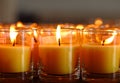 Church candles in yellow transparent chandeliers. Royalty Free Stock Photo