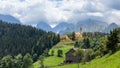 Church Cerkev Sveti Duh in Sol?ava with mountain range Kamnik Savinja Alps in Slovenia on a sunny summer day. Royalty Free Stock Photo