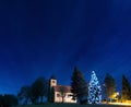 Chapel with a christmas tree under the night sky Royalty Free Stock Photo