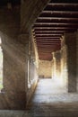 Church cloister interior. Some archs and sun rays throw the dust. Empty copy space