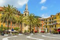 The church and colourful buildings stand proud in the central square in Lerici, Italy