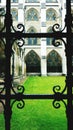 Church courtyard through wrought iron window