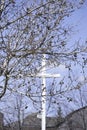 Church cross outdoors behind a tree