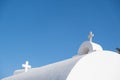 White orthodox greek church with cross on clear blue sky background. Summer vacation destination Royalty Free Stock Photo