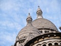 Church domes with intricate detail under blue sky with light clouds
