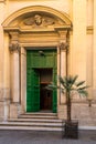 Church entrance door with a palm tree Royalty Free Stock Photo