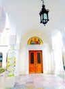 Church entrance icon above the door ribbon on a column