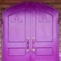 Church entrance - wooden doors.door of church. Close up of violet church doors Royalty Free Stock Photo