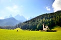 Church in the foothills of the Dolomites. Funes Valley, Dolomites, Italy. St John church under autumn sun Royalty Free Stock Photo