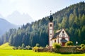 Church in the foothills of the Dolomites. Funes Valley, Dolomites, Italy. St John church under autumn sun Royalty Free Stock Photo