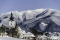 Church in the foreground and temple high mountains full of snow