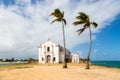 Church and fortress of San Antonio on Mozambique island, with two palm trees on sand. Indian ocean coast, Nampula province.